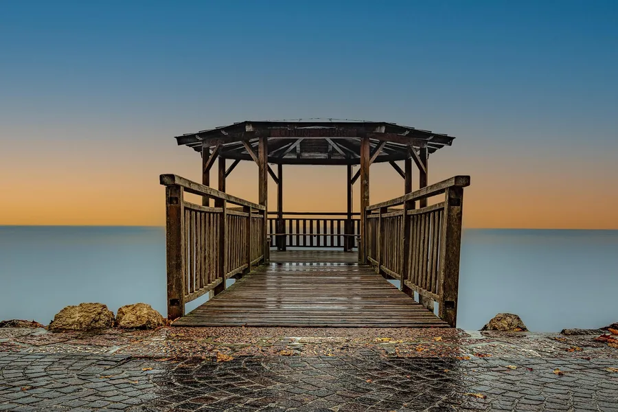 Wooden pier deck wet after rain, a constant-exposure setting for wood