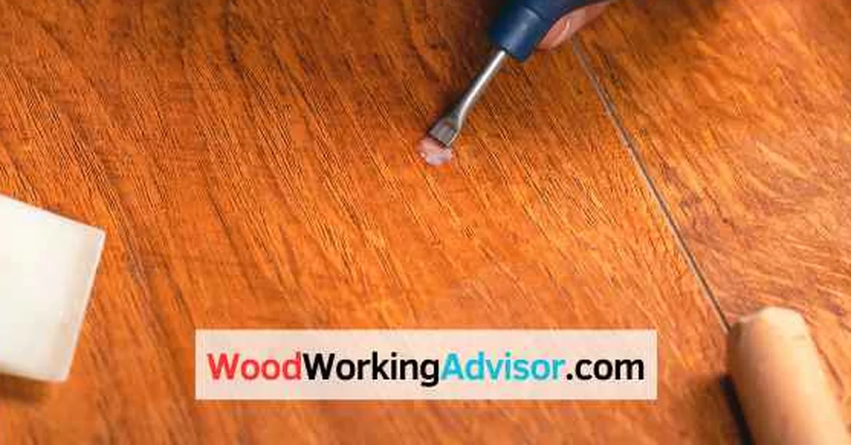 Buffing a white heat mark off a wood table with a sanding tool