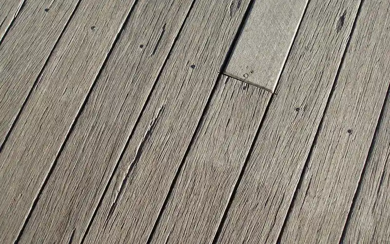 close-up of weathered wood deck boards showing natural grain and grey patina