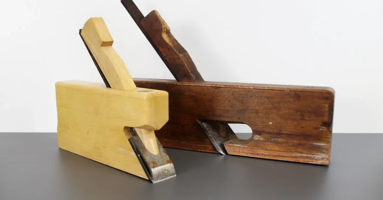 Carpenter using a hand plane to smooth a wood surface before applying finish
