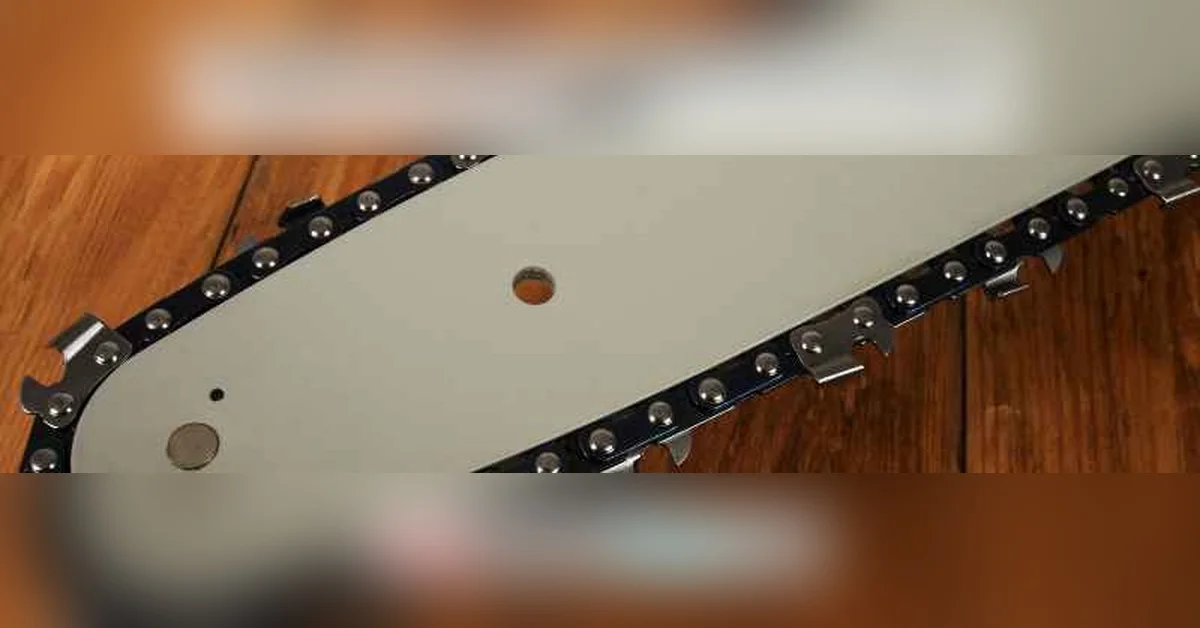 Chainsaw bar and chain showing drive links where the direction arrow is stamped