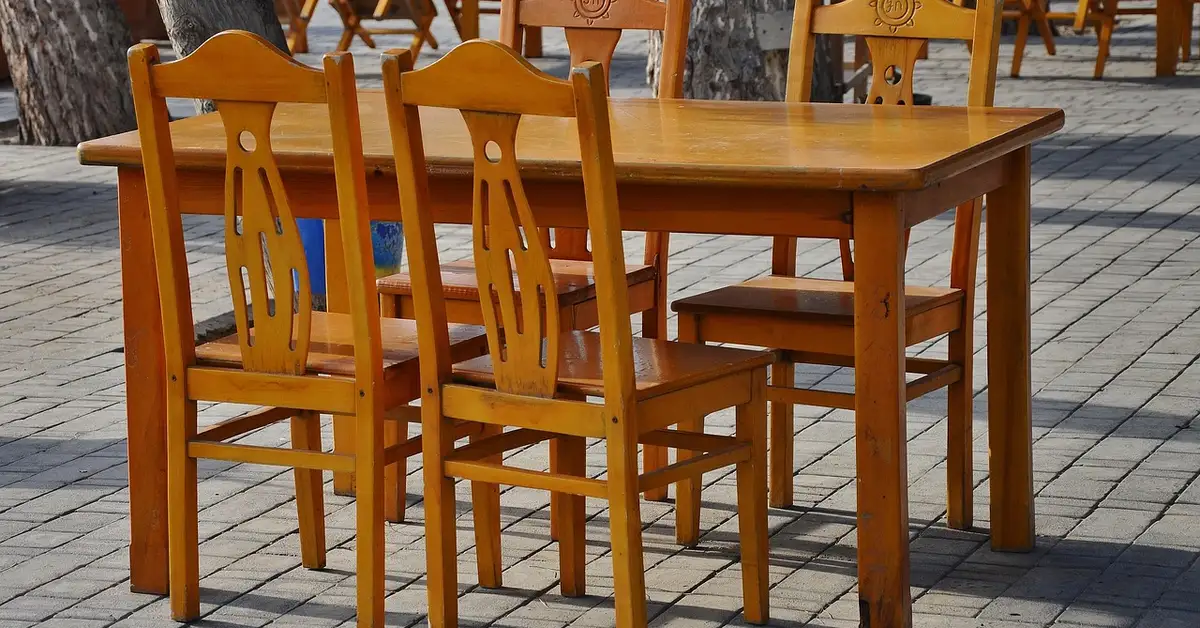 Set of cheap wooden dining chairs around a wood dining table