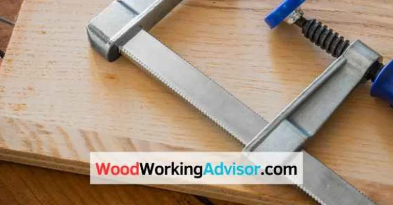 G-clamp holding two wood boards together on a workbench