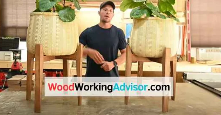 DIY wood plant stand with 2x2 legs holding two large potted plants in a workshop