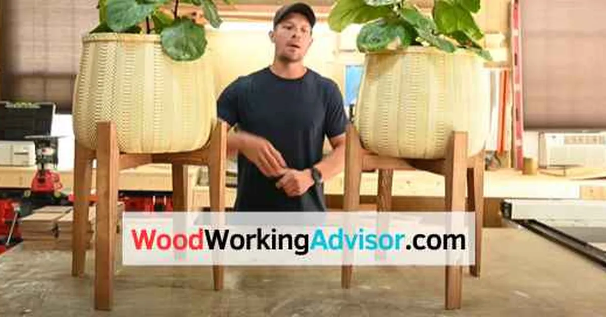 DIY wood plant stand with 2x2 legs holding two large potted plants in a workshop