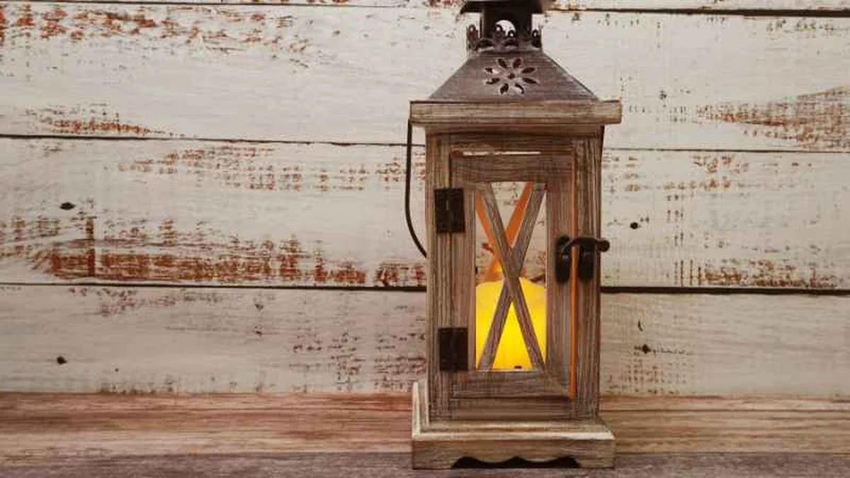 Small wooden lantern with a distressed finish and an LED candle