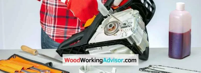Adjusting the L and H carburetor screws on a Husqvarna chainsaw on a workbench