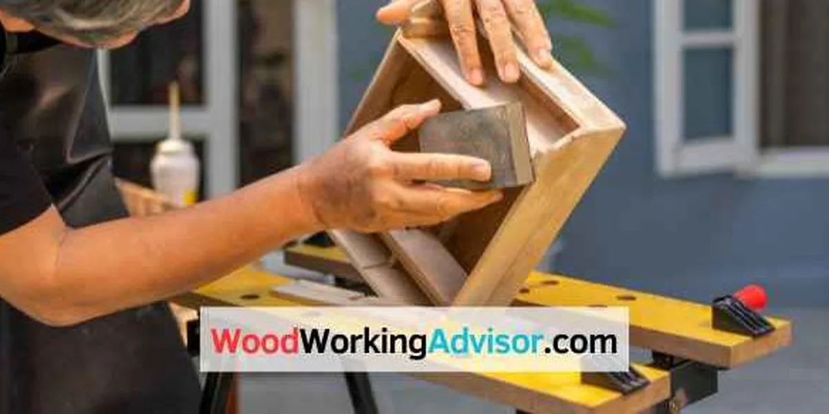 Sanding a wooden birdhouse frame, one of several small woodworking projects