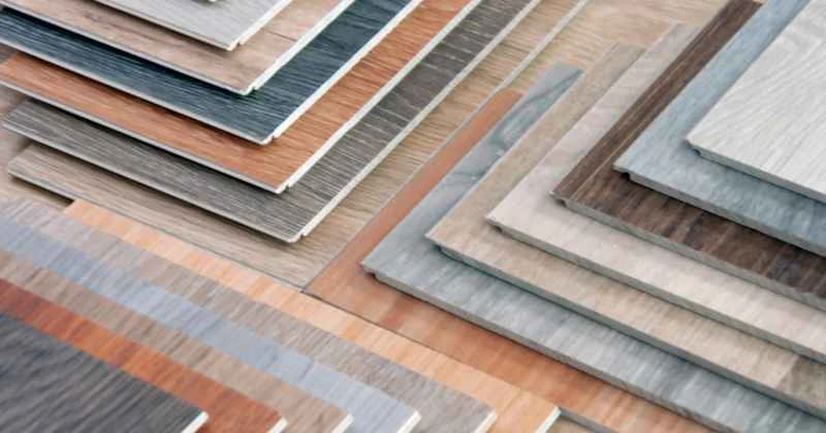 Fan of laminate sheet samples in different wood-grain patterns, the type applied to a plywood substrate