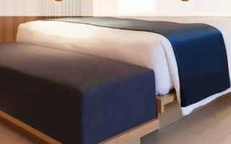 finished bedroom accent wall with MDF panelling behind the bed