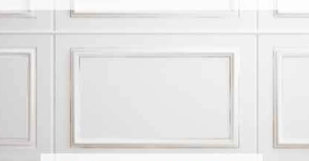 MDF board and batten wall panelling with painted trim molding, close-up view