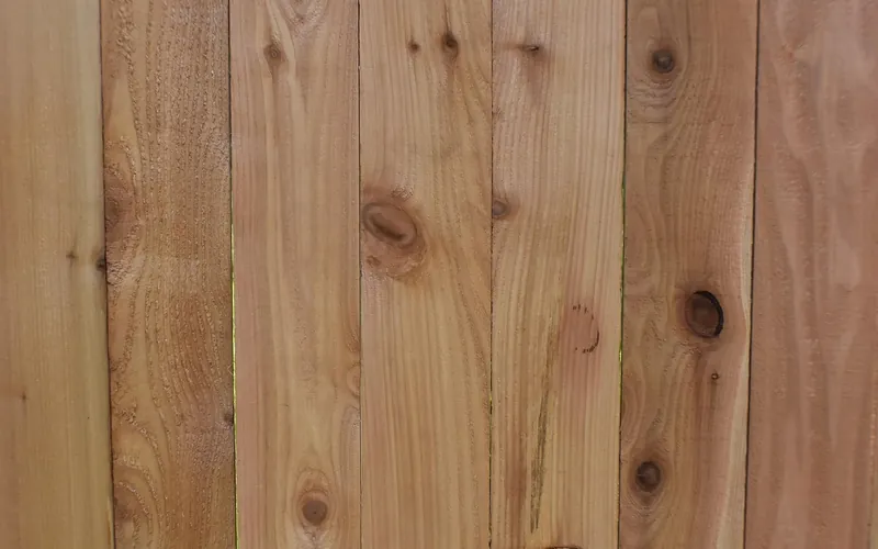 New raw cedar fence boards with knots and grain before staining