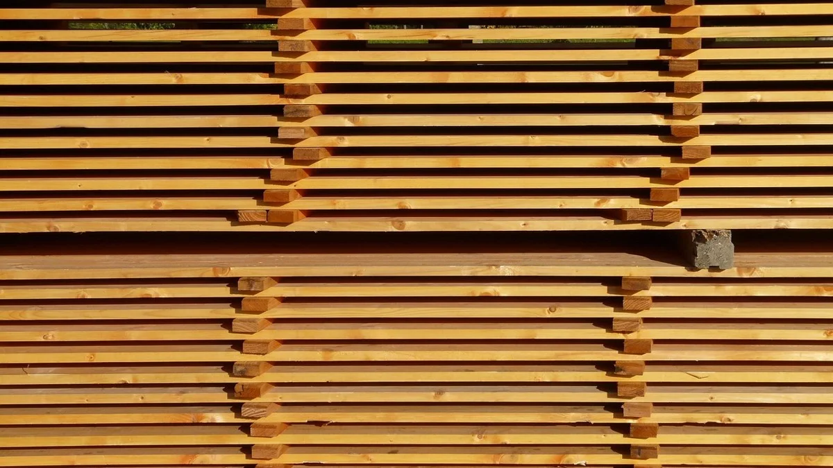 Stacked and stickered lumber boards showing board thickness layers