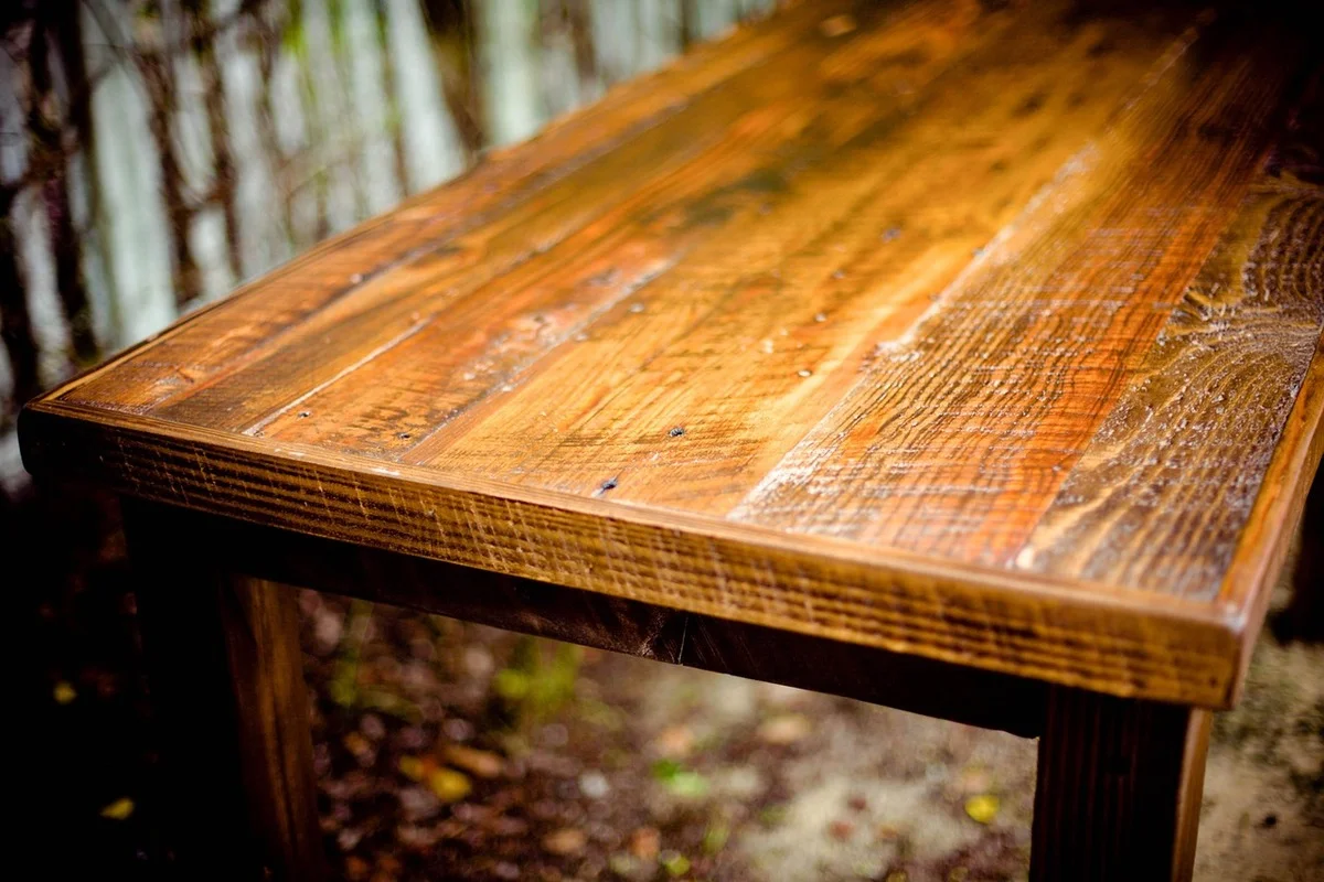 Stained wooden outdoor table with warm amber finish