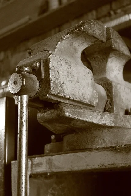 Close-up of a metal vise screw and jaw mechanism on a workbench