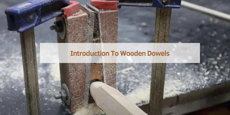 Square wood blank clamped in a shop-made dowel plate jig before shaping