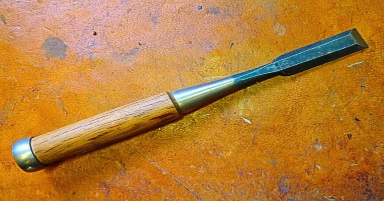 Close-up of a wood chisel bevel-edge blade with wooden handle