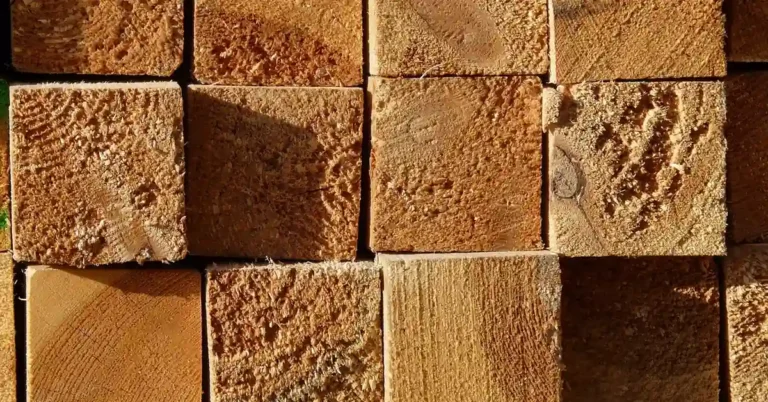 stack of pressure treated lumber boards showing sawn end grain
