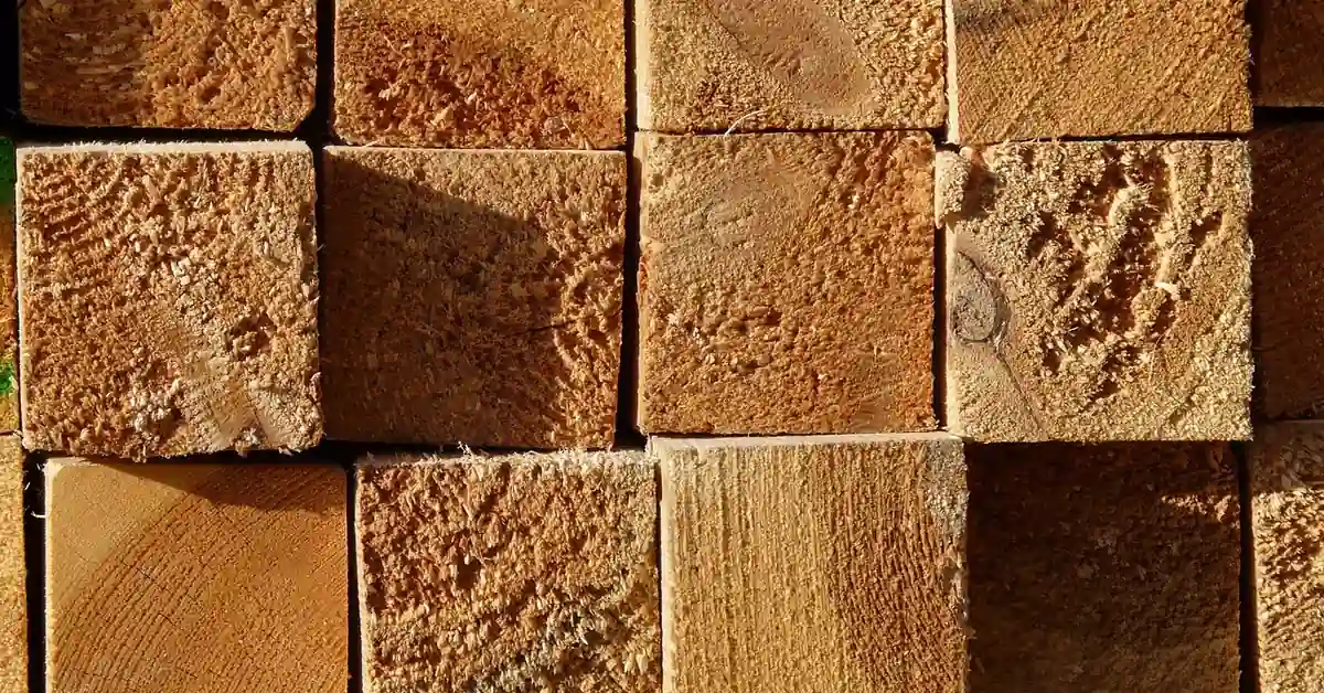 stack of pressure treated lumber boards showing sawn end grain