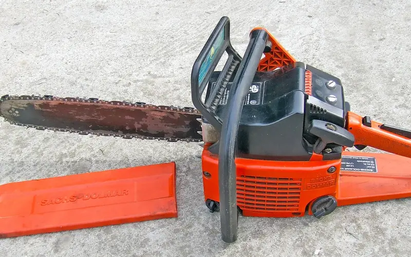 chainsaw guide bar and chain removed for maintenance and sharpening
