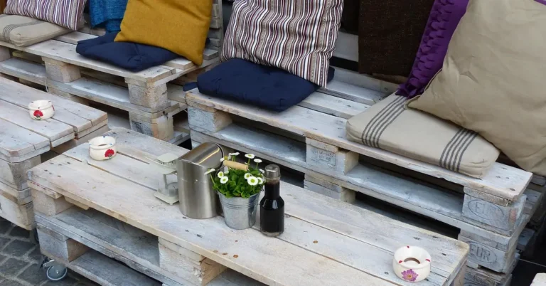 DIY pallet wood outdoor bench and table with cushions on a patio