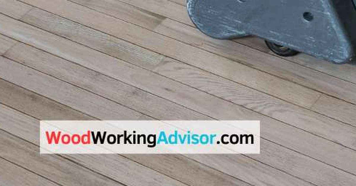 Drum sander removing old finish from a hardwood floor during refinishing