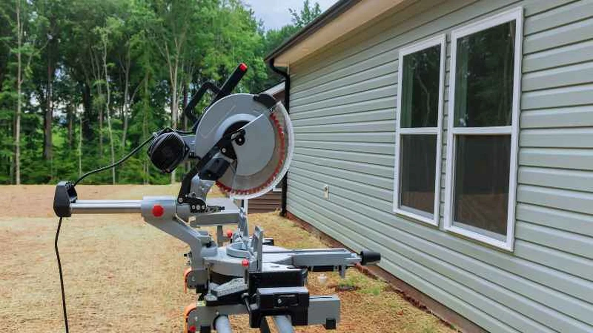 Miter saw set up on a wheeled stand at an outdoor job site