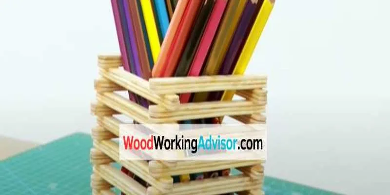 Popsicle stick pencil holder craft with colorful pencils