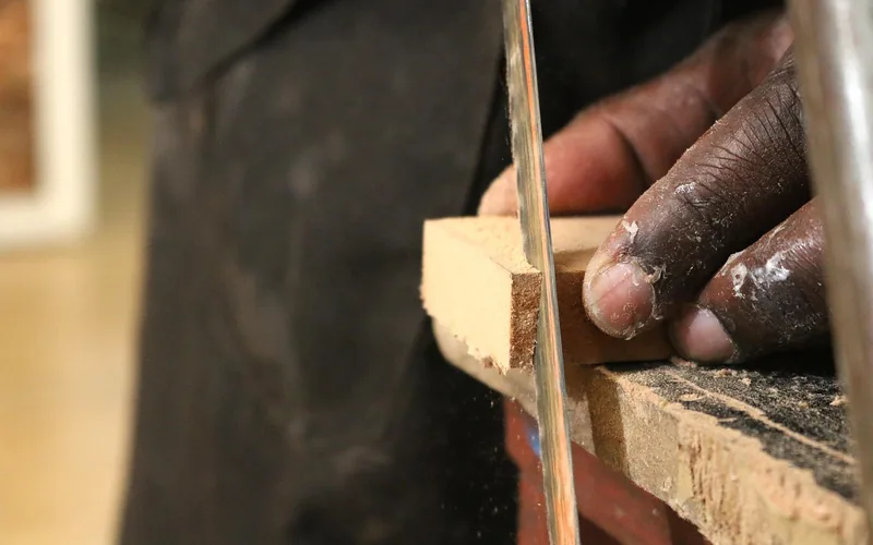close-up of a board being ripped on a table saw with sawdust collecting at the blade close-up of a board being ripped on a table saw with sawdust collecting at the blade