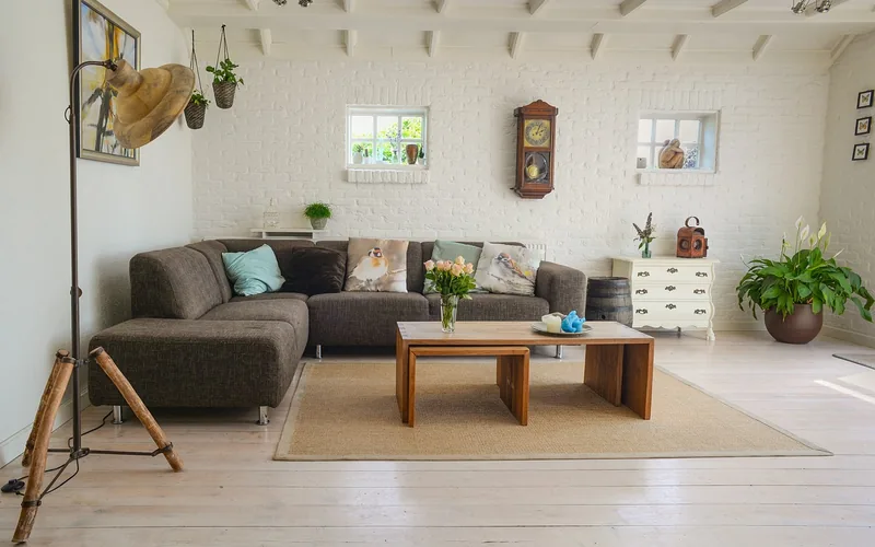round wood coffee table styled with fresh flowers in a bright modern living room