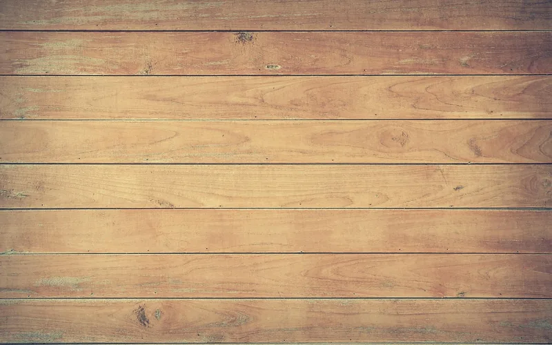close-up texture of unfinished hardwood boards ready for on-site sanding and refinishing