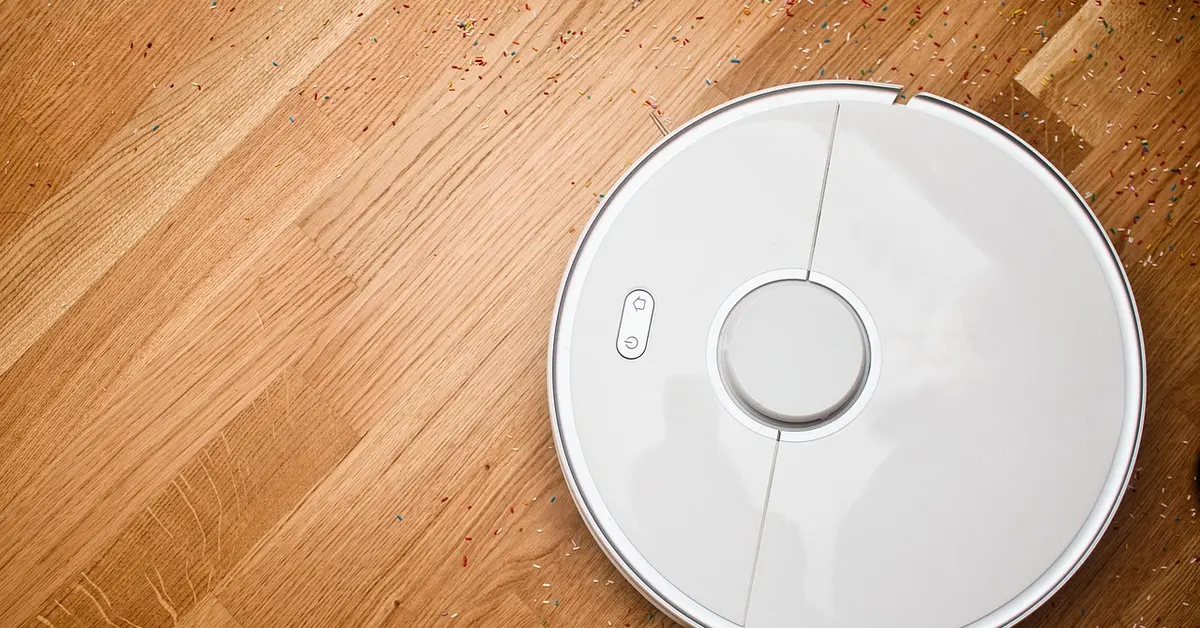 Robot vacuum cleaning debris off a hardwood floor