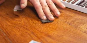 Applying matching stain to a repaired nick on a wood floor