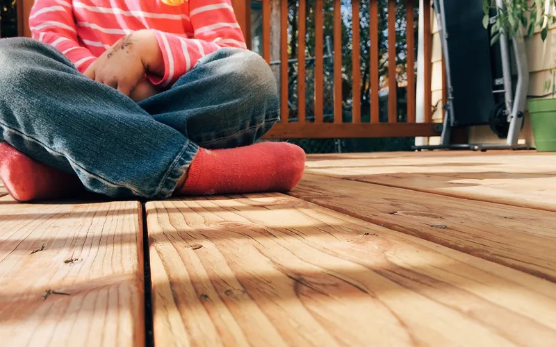 close-up of deck boards and railing showing wood grain texture on a backyard deck