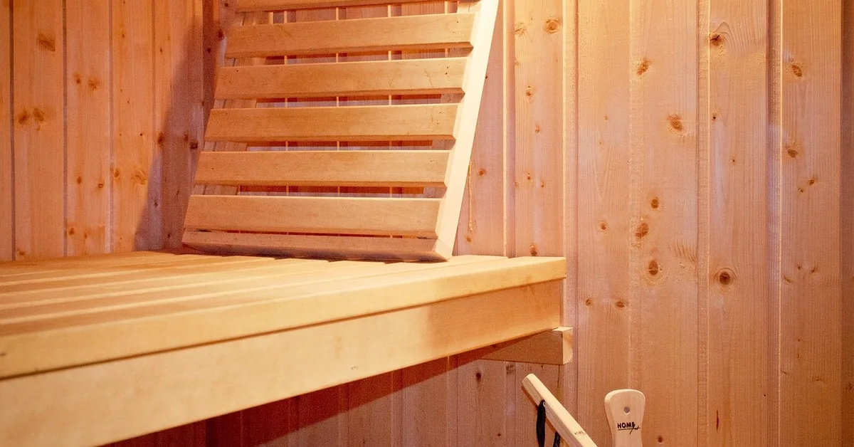 Light-toned cedar wood plank wall paneling installed vertically in a warm interior room Light-toned cedar wood plank wall paneling installed vertically in a warm interior room
