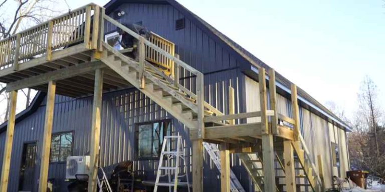 Pressure-treated 2x12 stair stringers being installed for a new backyard deck staircase