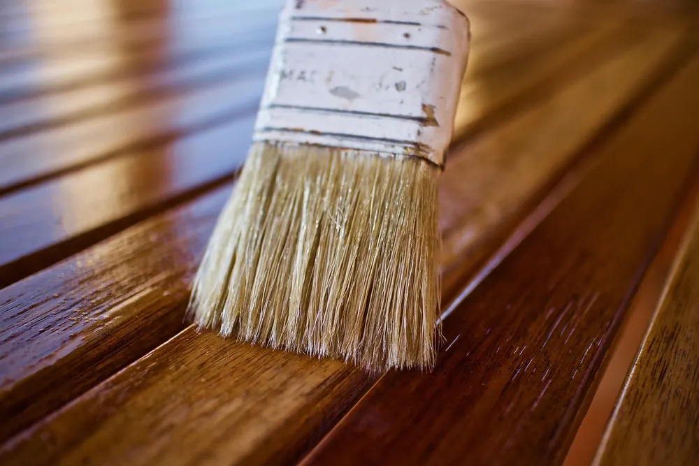 Brushing on a wood finish coat for moisture resistance Brushing on a wood finish coat for moisture resistance