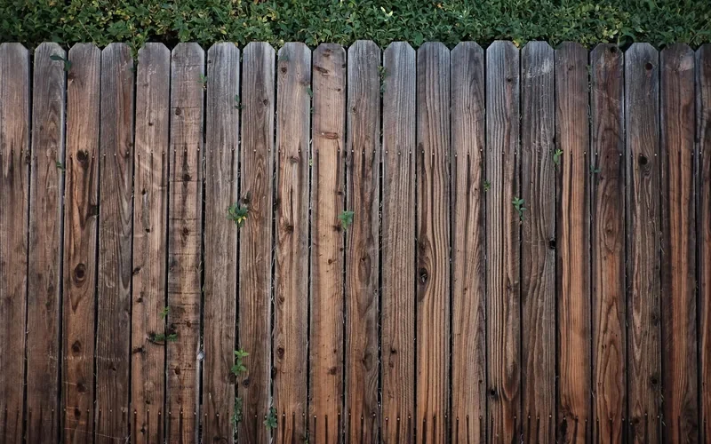 Brown stained vertical wood fence boards with visible grain