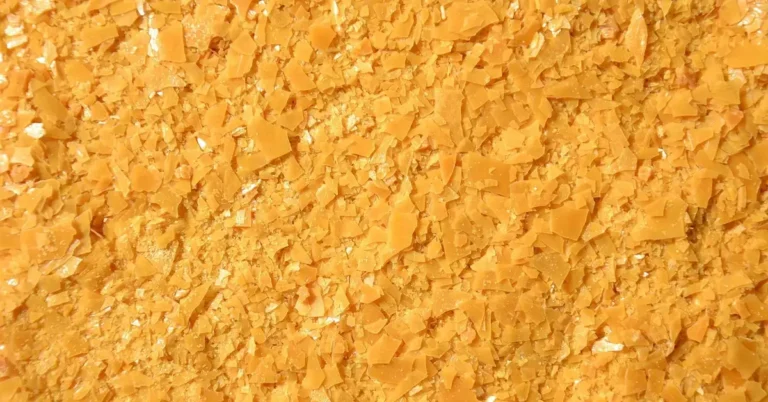 Yellow carnauba wax flakes, a hard natural wax used in many paste waxes