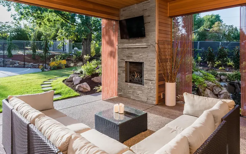 Finished composite deck with patio furniture in a backyard setting