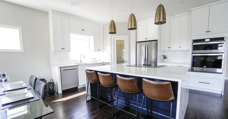 Modern kitchen with dark hardwood floors and a white island