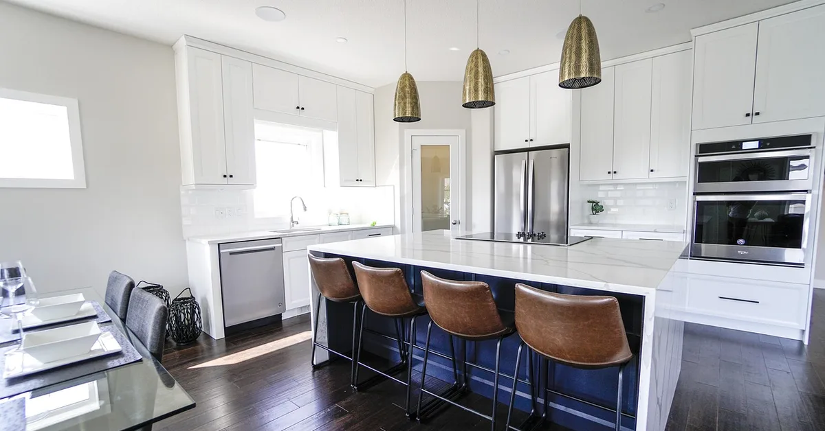 Modern kitchen with dark hardwood floors and a white island