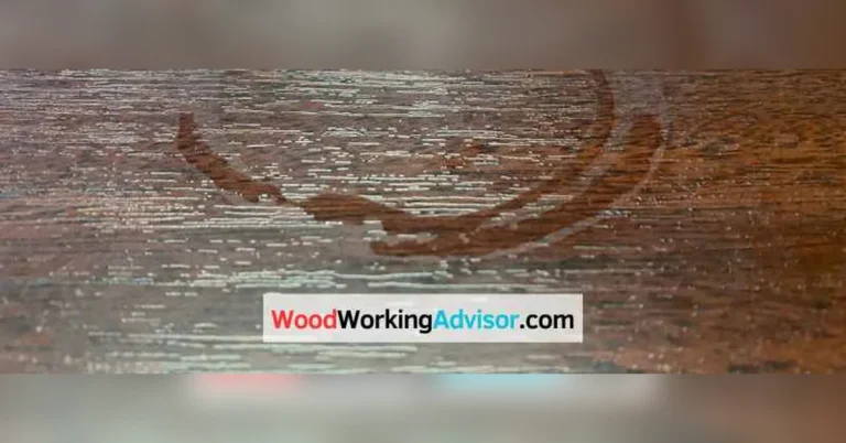 White water ring stain trapped in a wood table's finish before removal