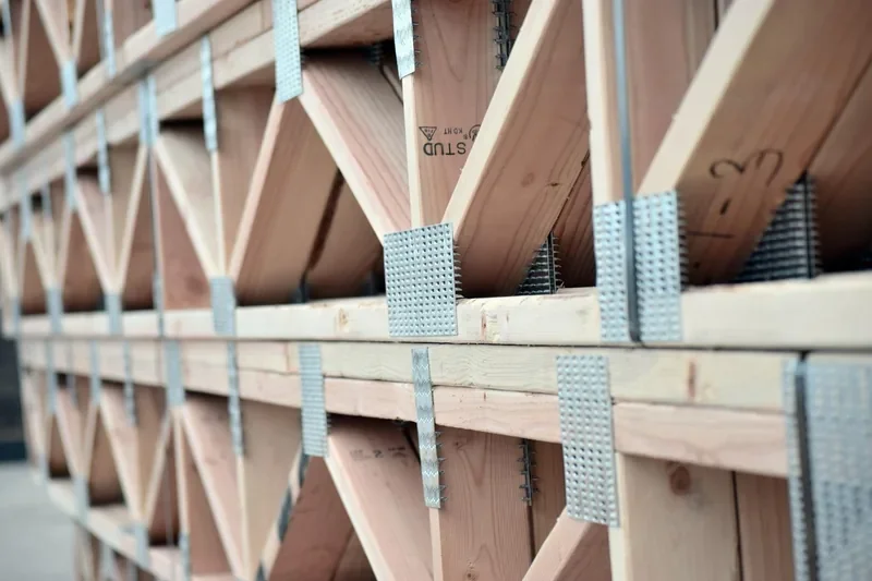 Stacked wood floor trusses showing the framing that hardwood boards run across Stacked wood floor trusses showing the framing that hardwood boards run across