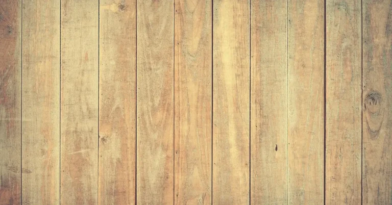 Stacked oak hardwood lumber planks showing natural wood grain texture and density variations