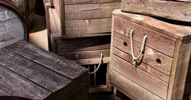 Stack of weathered wooden shipping crates with rope handles