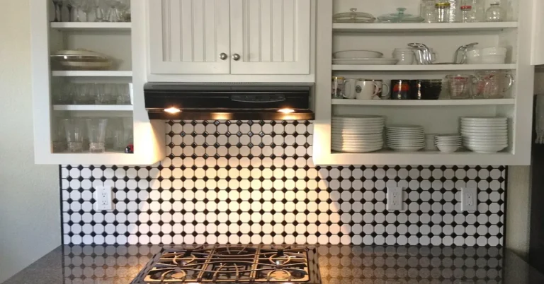 White painted wood veneer kitchen cabinets with open glass-front doors
