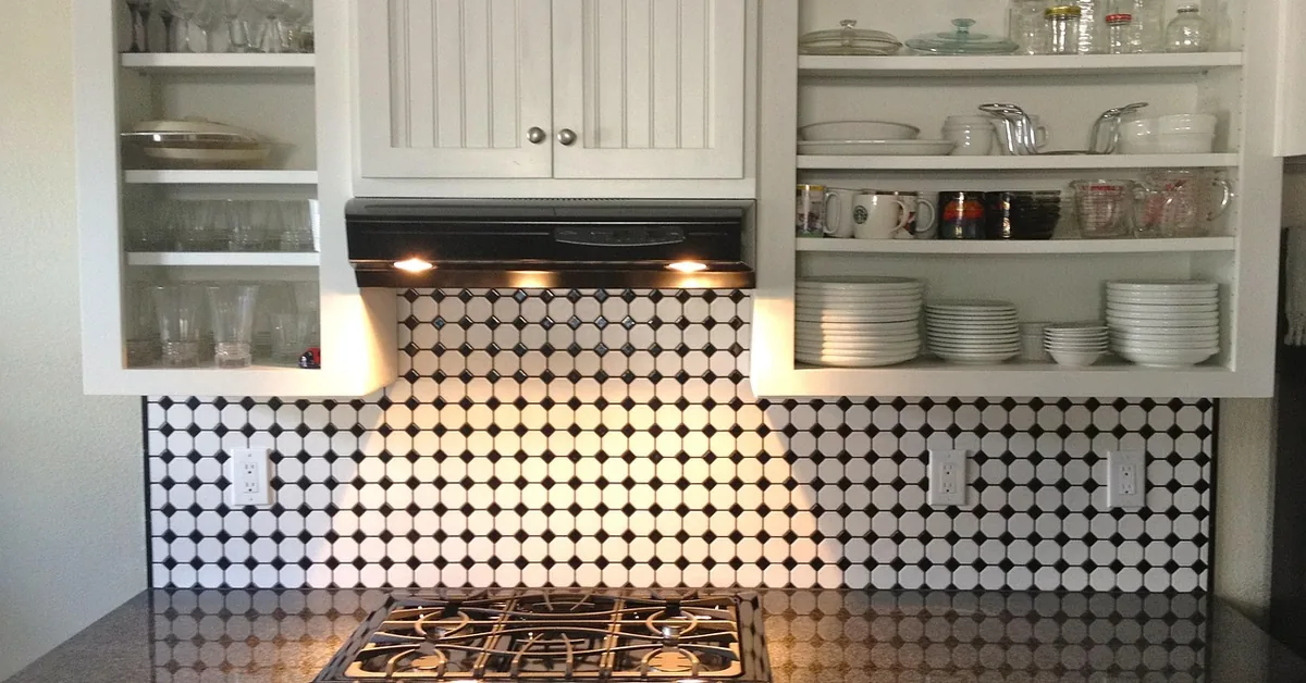 White painted wood veneer kitchen cabinets with open glass-front doors