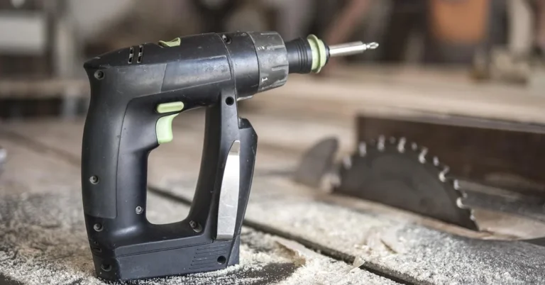 Cordless drill and table saw blade in a home workshop