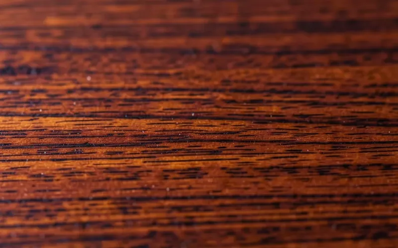 close-up macro photo of polished mahogany wood grain showing its deep reddish-brown color and fine straight grain close-up macro photo of polished mahogany wood grain showing its deep reddish-brown color and fine straight grain